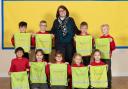 St Andrew’s Headteacher Becky Black with pupils and their hi-vis kit bags