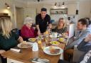 Paul serving a birthday meal to residents
