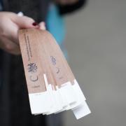 A marshall holds wristbands at the end of the queue near Tower Bridge, London (Picture: PA)