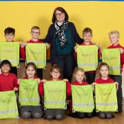 St Andrew’s Headteacher Becky Black with pupils and their hi-vis kit bags