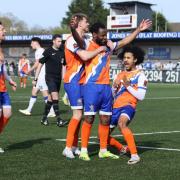 Arms and the man - Shaq Coulthirst celebrates with his team-mates after scoring for Braintree Town at Havant and Waterlooville