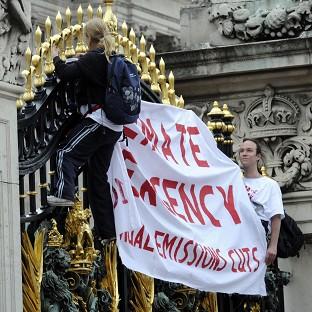 Protesters from the Climate Siren group scaled the gates of Buckingham Palace