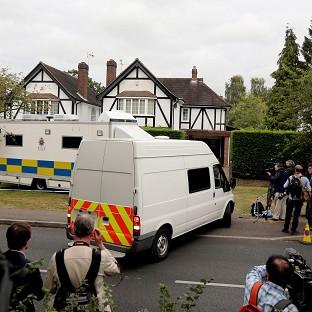 Police and the media outside the home of Saad Al-Hilli in Claygate, Surrey