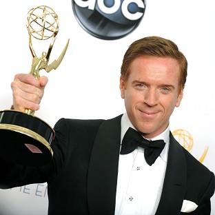 British actor Damien Lewis holds him Emmy, awarded to him for his role in Homeland (AP)