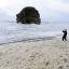 Aron Martin, 17, has his hat blown off on Marsden beach near South Shields as heavy seas churn up masses of foam along the beach