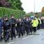 A parade of family, friends and colleagues walk to a vigil near Abbey Gardens, Hattersley for two murdered Greater Manchester police