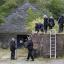 Police officers search outside a house called Mount Pleasant in the village of Ceinws, believed to be the last known residence of Mark Bridger