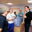Prime Minister David Cameron chats to nurses during a visit to a hospital in Oxford where he met teenage patients and their parents