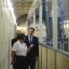 David Cameron, right, is escorted around C wing by prison officer Margaret Vaughan, during his visit to Wormwood Scrubs in west London
