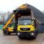 A Highways Agency worker loads gritting salt as snow hits parts of the country