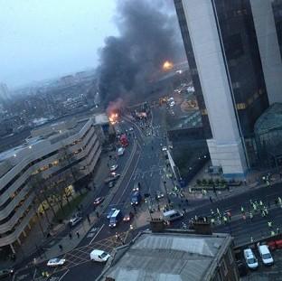 The scene where a helicopter crashed in central London after hitting a crane on top of a tower block by the River Thames (Victor Jimenez/PA)