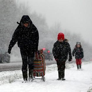 A mother and her children make thier way through the snow near Worcester