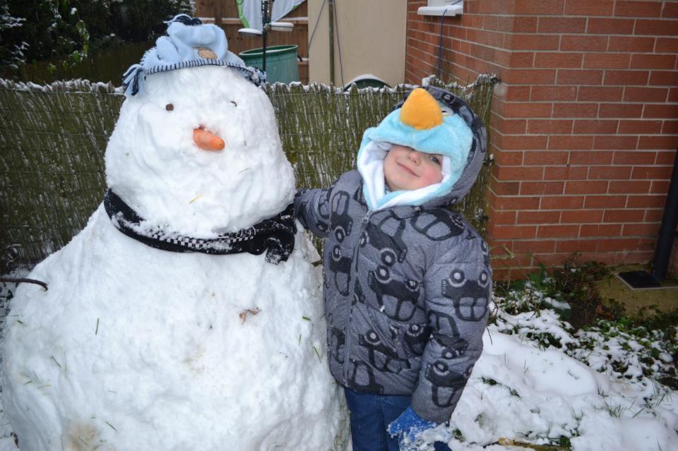 Four-year-old Tommy Allen and his snowman Frosty