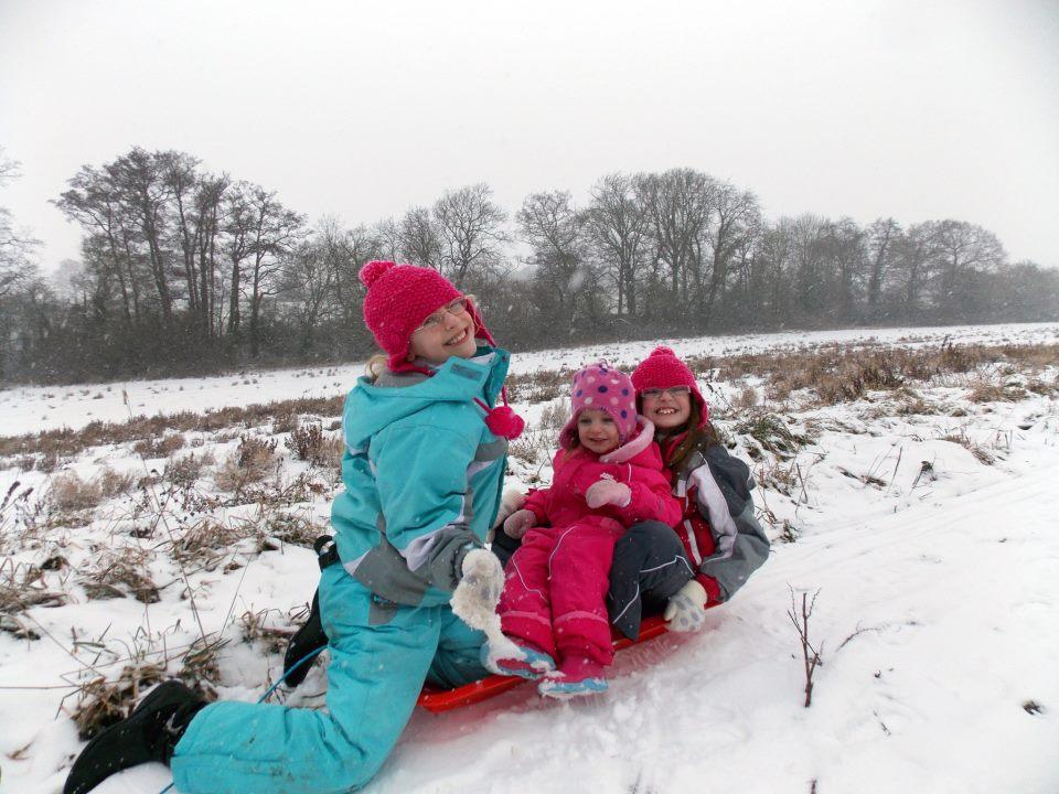Charlotte, eight, Evie, three, and Abigail, nine, go sledging in Bocking on Sunday afternoon.