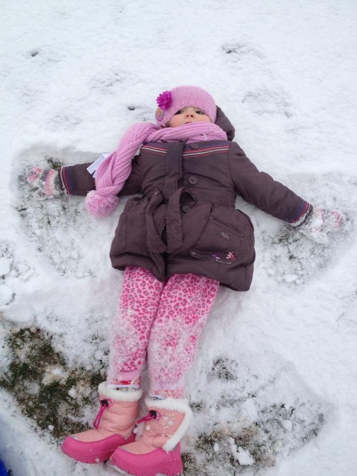 Three-year-old Grace Southgate making a snow angel