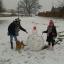 Liberty Griffin with sister Olivia, dog Ecko and their snowman in Witham. Liberty Griffin with sister Olivia, dog Ecko and their snowman in Witham.