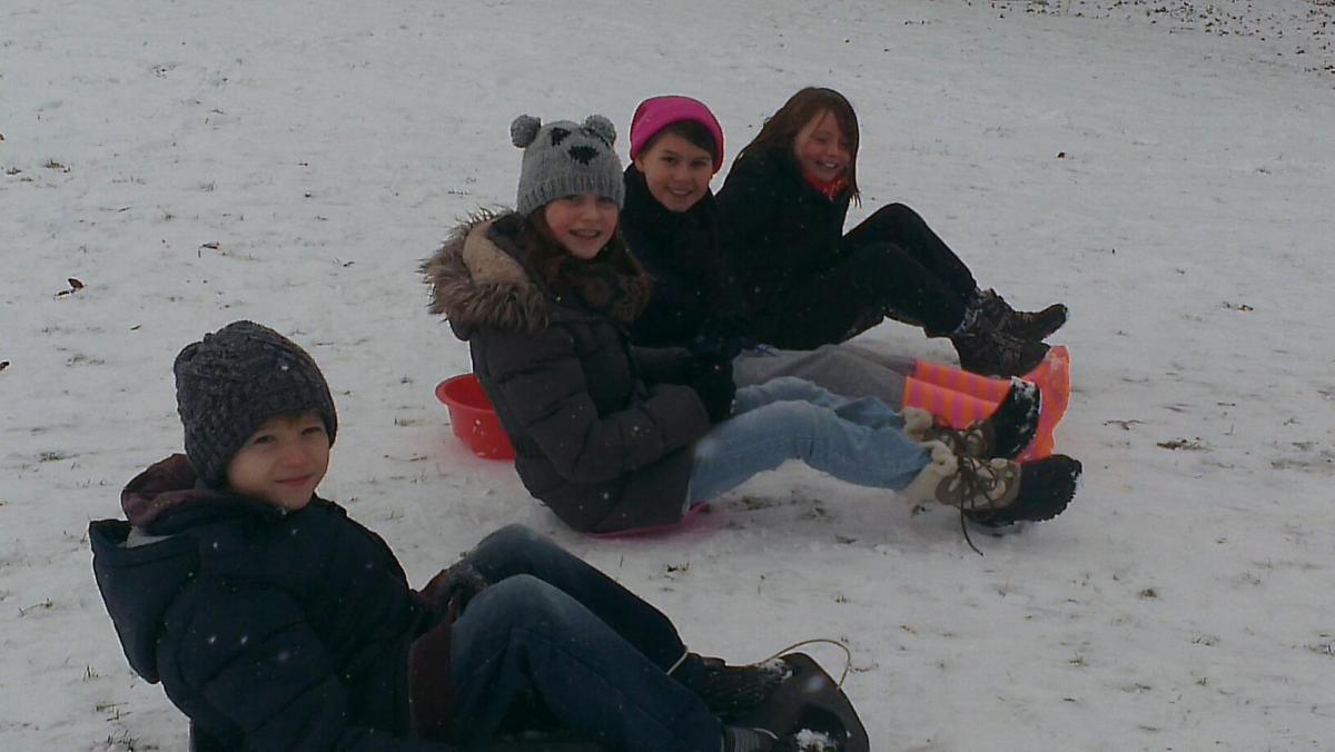 Kayleigh Gannon and Aimee Gannon with their friends just about to start sledging at The Hill at Cut Throat Lane, Witham