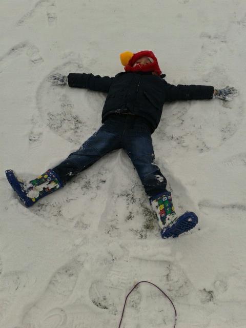 Connor Turland making a snow angel.