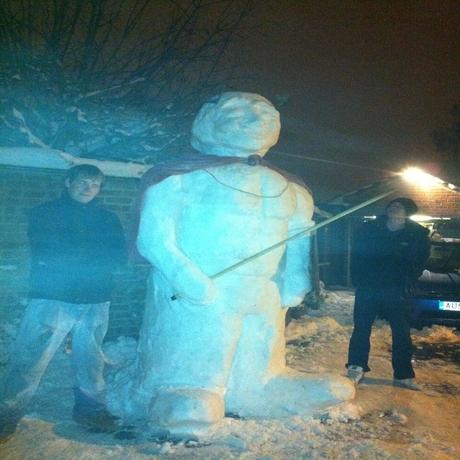 Justin Elms, his girlfriend Alix Harris and his brother Chris Elms took four hours to make this 8ft snowman