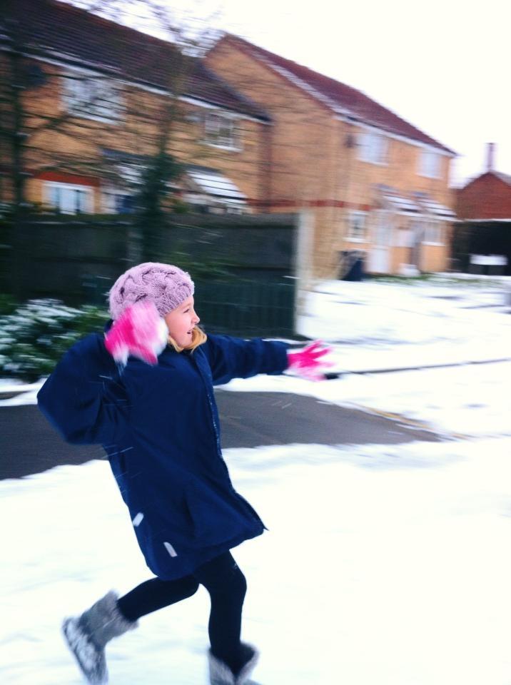 Lolly Cooke snowball fighting with a great aim in Castle Hedingham