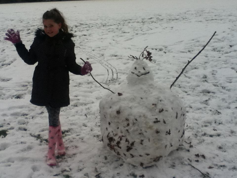 Emily Sillett, nine, and her snowman in Great Maplestead