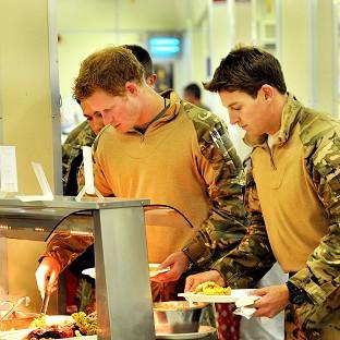 Prince Harry lining up at the self-service food section behind fellow Apache pilot Simon Beattie