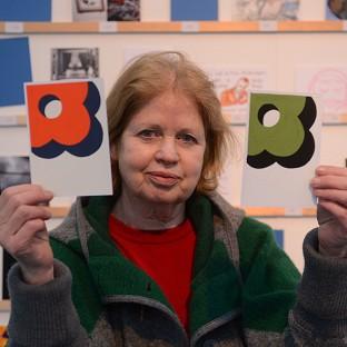 Dee Refaie with her postcard by the fashion designer Orla Kiely which she paid 45 pounds for at the Royal College of Art annual postcard sale