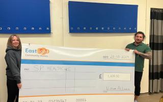 Helpful - SP Healthcare staff with a cheque for £1,250
