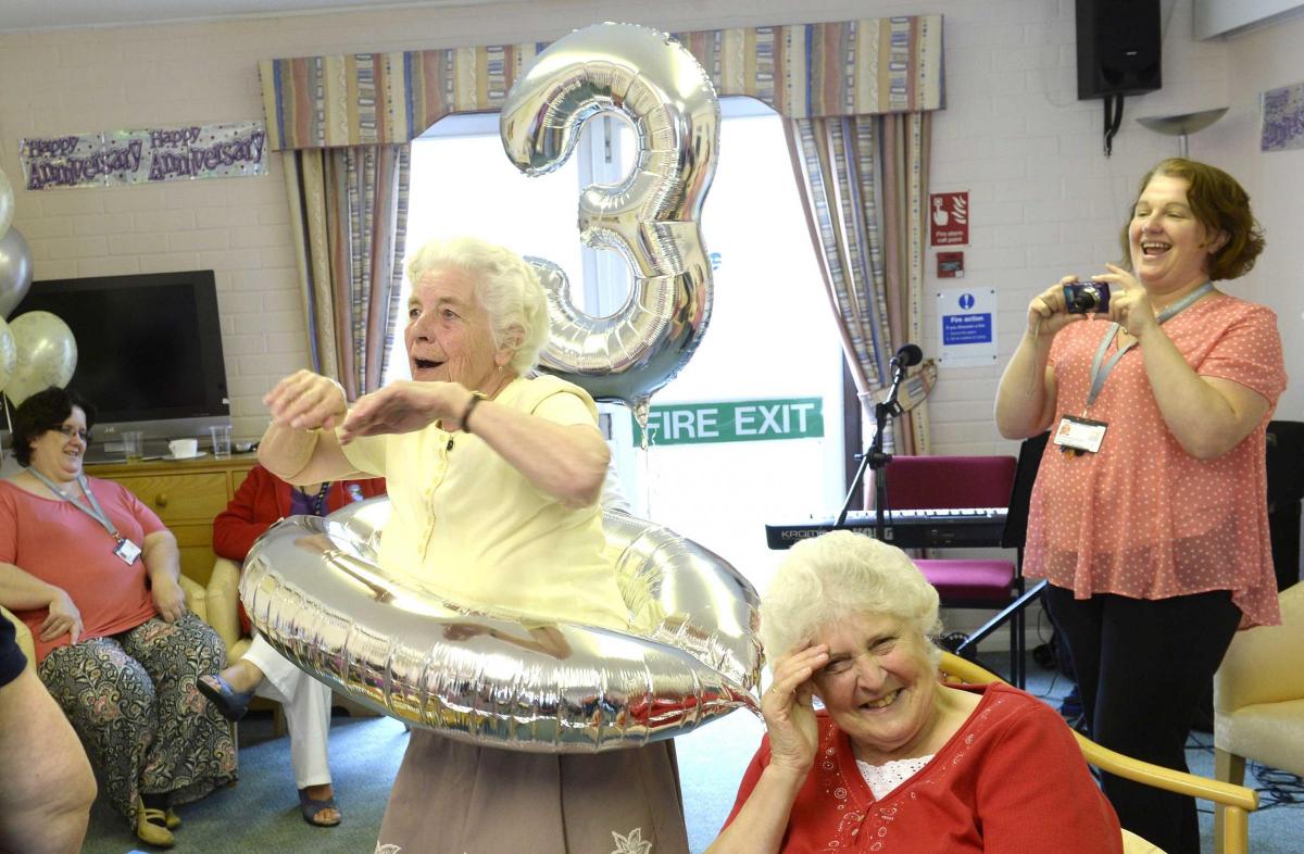 Debbie Brooker using her balloon as a rubber ring at Oatfield Close care home's 30th anniversary celebrations