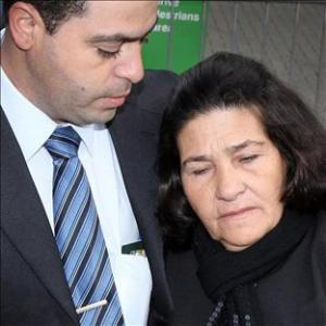 Maria Otone de Menezes arrives at the inquest with eldest son Giovani de Menezes