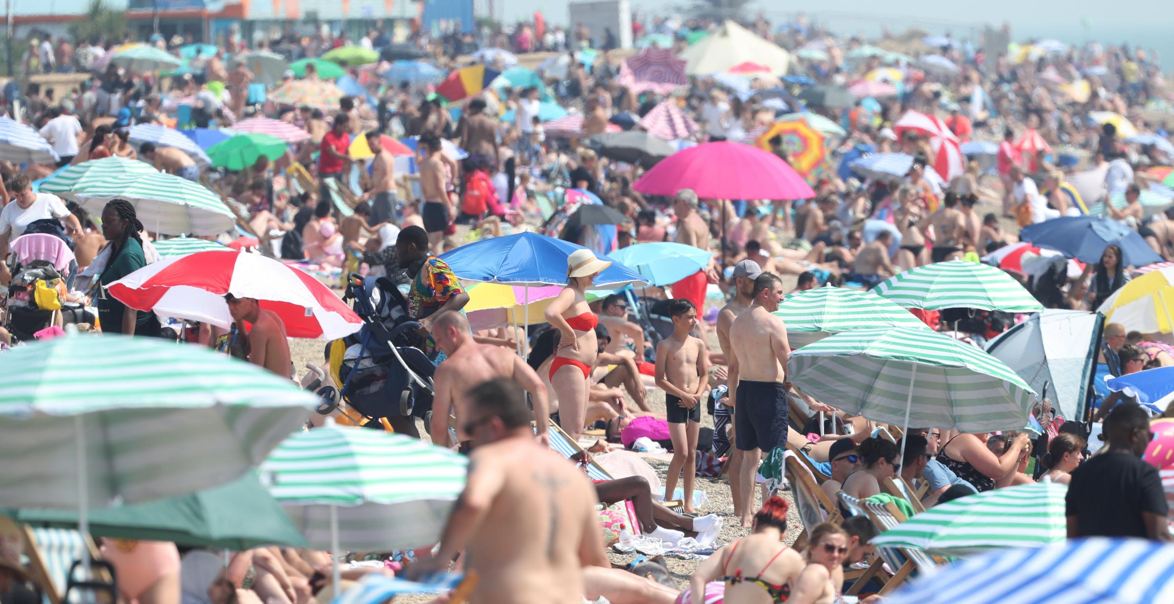 People enjoy the hot weather at Southend beach in Essex..