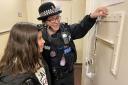 A Braintree police officer shows one of the young visitors the old cells. Photo: Essex Police