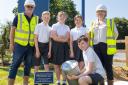 SPECIAL BURIAL: Pupils and Dandara staff with the time capsule