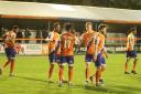 Big win: Shaq Coulthirst celebrates with his Braintree Town team-mates after scoring against Hampton and Richmond.