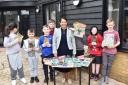 Supportive - MP Dame Priti Patel with Woodend Farm School students and a collection of donated books