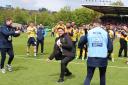 Oxford United head coach Des Buckingham celebrates with the away end at full-time