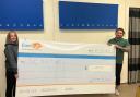 Helpful - SP Healthcare staff with a cheque for £1,250