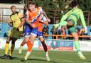 High kicks: Joe Grimwood battles it out for Braintree Town against Chesham United in the FA Cup.