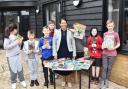 Supportive - MP Dame Priti Patel with Woodend Farm School students and a collection of donated books