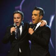 Olly Murs performs with Robbie Williams on Saturday (PICTURE: Ken McKay)