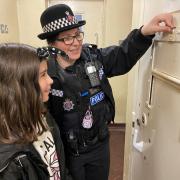 A Braintree police officer shows one of the young visitors the old cells. Photo: Essex Police