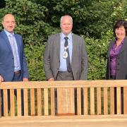 Councillor Frankie Ricci, council chairman Andrew Hensman, and councillor Wendy Schmitt with one of the benches