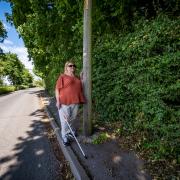 Janice Parker was refused a guide dog because her nearby footpath is damaged and blocked by overgrown shrubs (pics: SWNS)