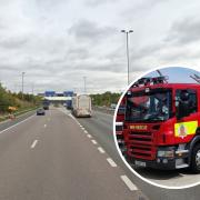 Fire crews are working to free a driver who was trapped in a vehicle following a crash on the M11