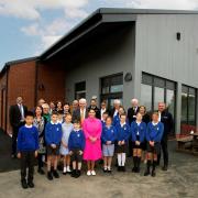 Building -Priti Patel and special guests with staff and students from Copford Primary School, in front of the new building