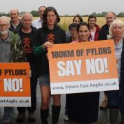 Campaigners - Priti Patel MP with Rosie Pearson (holding board) and campaigners against the pylons