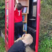 Helpers - Iona's children have been involved in transforming the disused telephone box in Stambourne