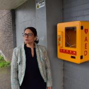 Vandalised - MP Dame Priti Patel next to the smashed case which is home to the defibrillator