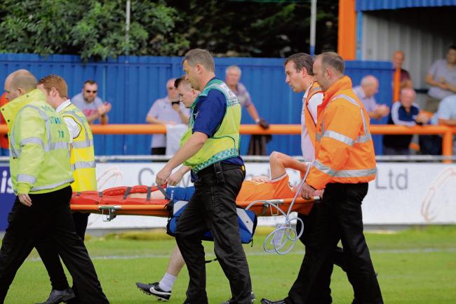 Matt Fry is stretchered off the pitch after suffering a knee injury against Tranmere. Picture: ALAN STUCKEY