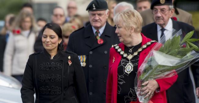 Returning - MP Priti Patel with Mayor of Witham JoAnn Williams and veterans during Remembrance Sunday service